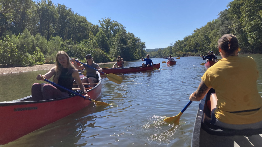 PhD students canoe on a lake